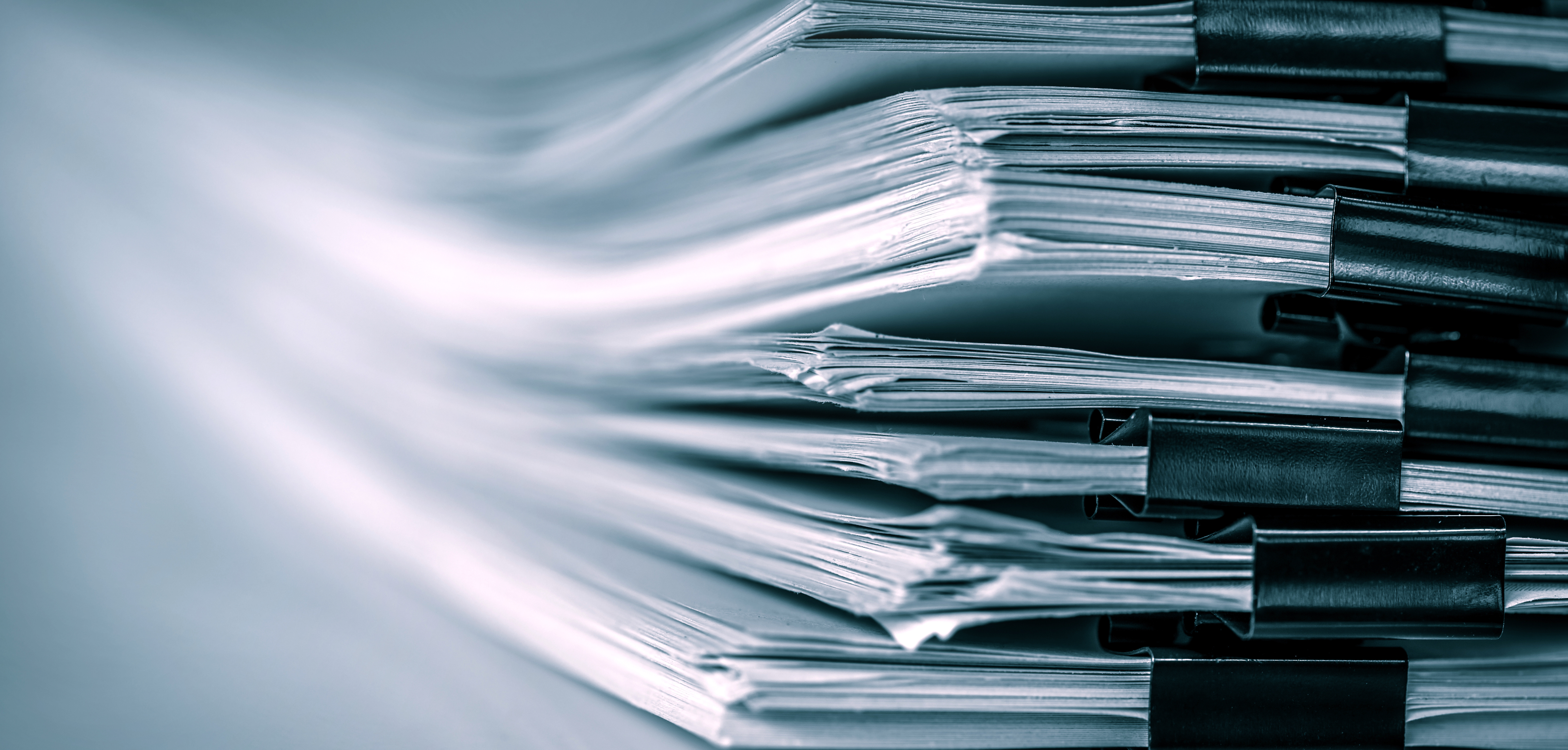 extreamely close up a report paper stacking of office working document , retro color tone